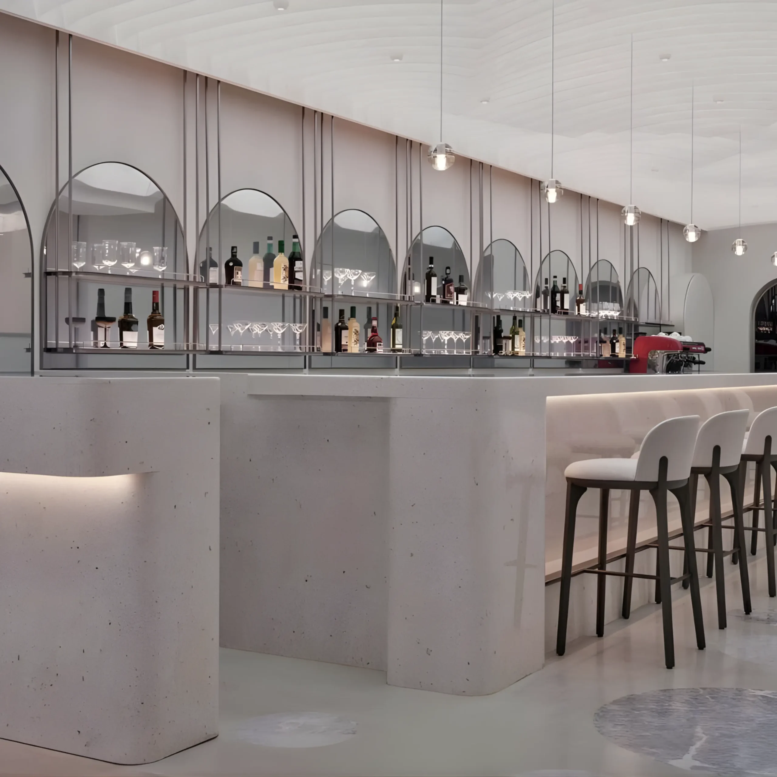Modern bar interior with a curved counter, high stools, and a back wall displaying bottles and glassware under arched mirrors, with pendant lights hanging from the ceiling.