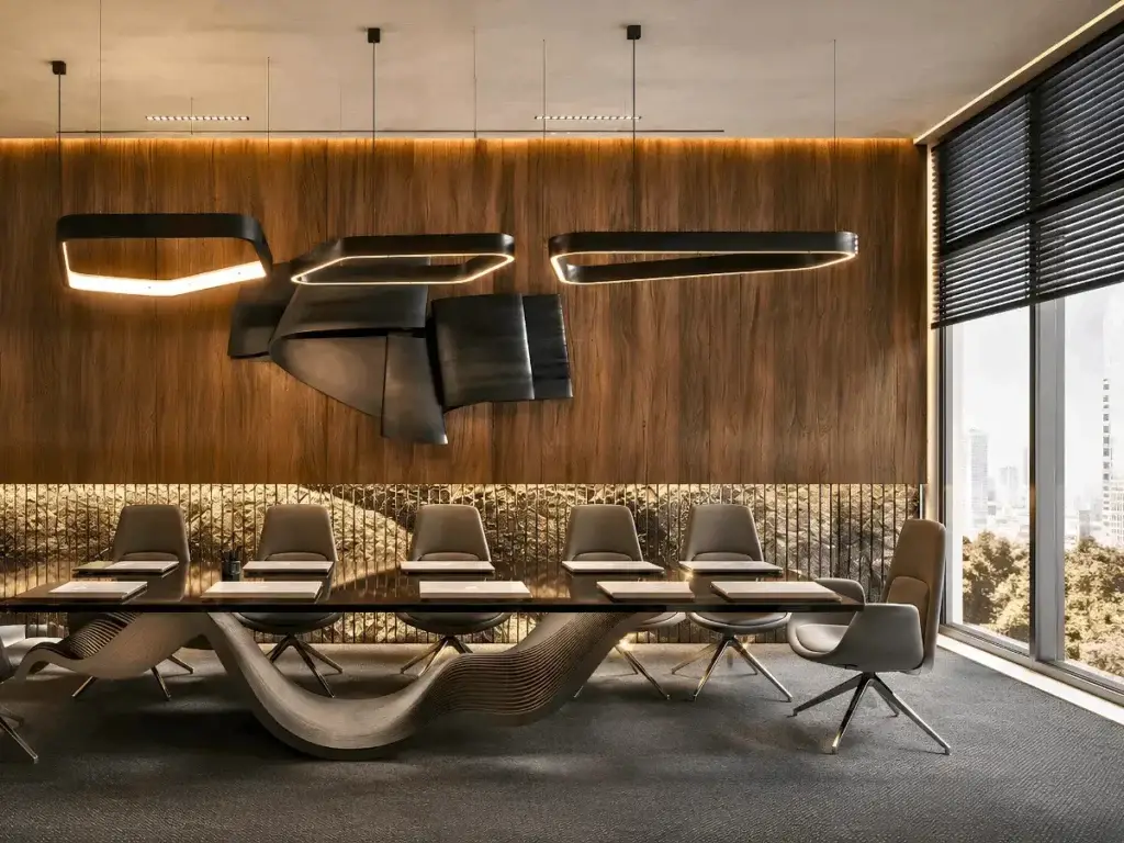 A modern conference room featuring a large table surrounded by ergonomic chairs, designed for collaborative meetings.