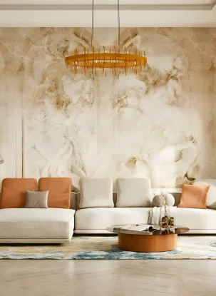 Elegant living room with a large cream sectional sofa, orange and beige cushions, a round wooden coffee table, an ornate wall mural, modern chandelier, potted plant, arched windows, and patterned rug. Residential interior fit out by interioritalia.