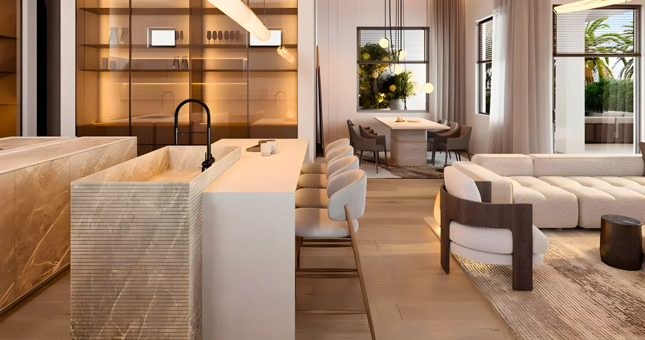 A modern open-concept living space with a minimalist kitchen island, bar stools, cozy seating area, and a dining table. Warm lighting and contemporary decor by interioritalia deliver a residential interior fit out that feels both inviting and stylish.